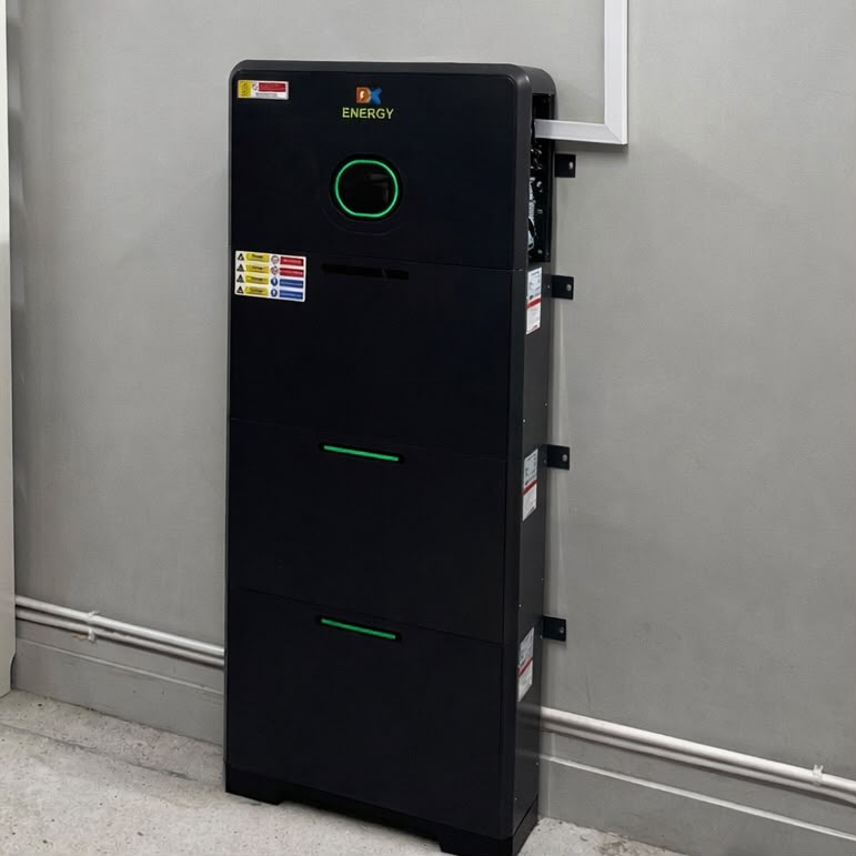 An indoor battery installation with circular green status display and stacked modules